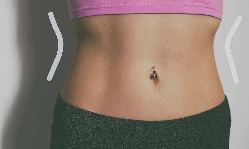 Stomach of a sporty woman with abs.